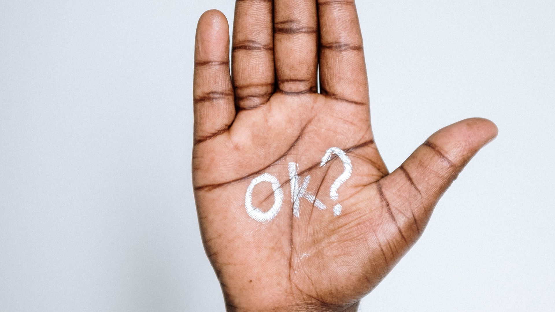 Schrift "Ok?" auf Handfläche 